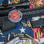 Patriotic Spin Targets The Second Amendment A rifle and handgun surrounded by ammunition on an American flag