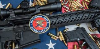 Patriotic Spin Targets The Second Amendment A rifle and handgun surrounded by ammunition on an American flag