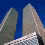 Backlash Erupts: Mayor Unwelcome At 9/11 Twin rectangular skyscrapers rising above a hotel facade against a clear blue sky