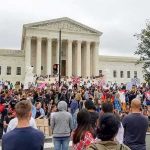 Cuba-Linked Network Targets U.S. Bases Crowd protesting in front of a neoclassical courthouse