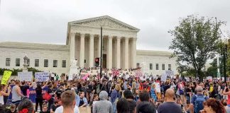 Cuba-Linked Network Targets U.S. Bases Crowd protesting in front of a neoclassical courthouse