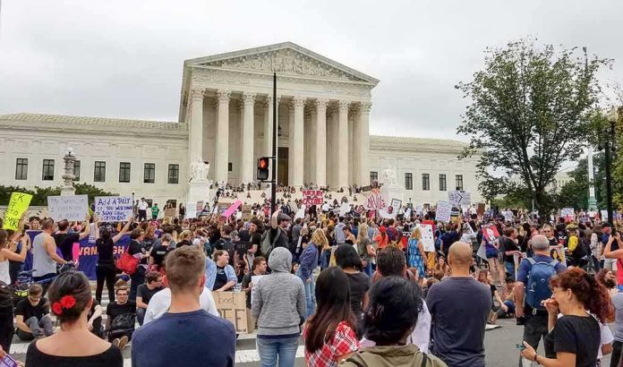 shutterstock_1199019826 Crowd protesting in front of a neoclassical courthouse