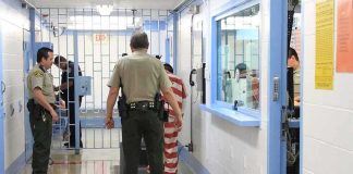 Double Execution Shocks Florida Corrections officers escort an inmate in a jail hallway
