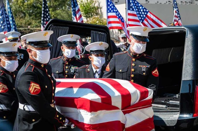 shutterstock_2042622047 U.S. Marines carry a flag-draped casket into a hearse