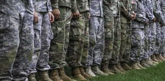 Base Hit in Jordan — Casualties Mount soldiers standing in formation wearing camouflage uniforms and boots