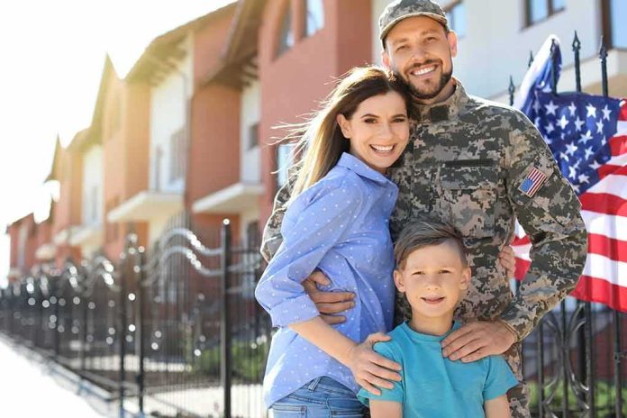 Military family posing together outside a suburban home