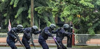 Mass Shooting Math Isn’t What It Seems Police tactical team advancing in rain