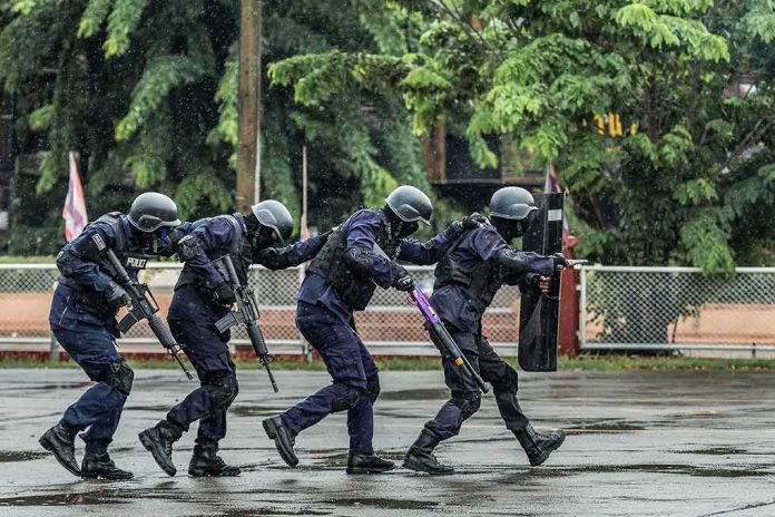 shutterstock_1115325713 Police tactical team advancing in rain