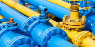 Congress Floats Nationwide AI Freeze Blue and yellow industrial pipelines with valves and flanges