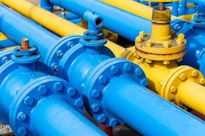 Blue and yellow industrial pipelines with valves and flanges