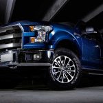America’s Surprising Truck Rebellion blue pickup truck in a dark parking structure