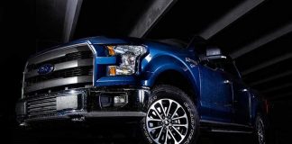America’s Surprising Truck Rebellion blue pickup truck in a dark parking structure