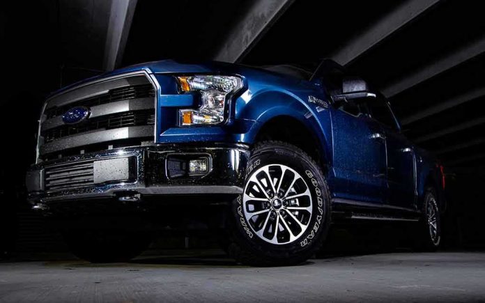 shutterstock_1144613591 blue pickup truck in a dark parking structure