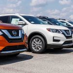 Row of Nissan SUVs parked at a car dealership