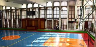 Indoor basketball court with blue floor and orange key areas