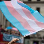 Transgender pride flag waving at a parade