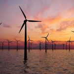 Trump Pays Billions—Wind Projects Vanish Offshore wind turbines at sunset over calm sea