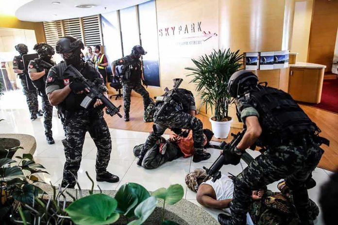 shutterstock_1469942693 Tactical police detain suspects in an office lobby