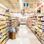 NYC’s Grocery Gamble: Membership Needed A grocery store aisle filled with various food products on shelves