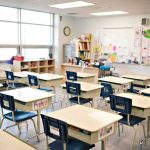 Teacher Of The Year Walks—Grades Quietly Flipped Empty classroom with rows of student desks and chairs