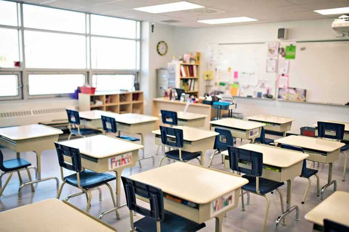 shutterstock_1553133782 Empty classroom with rows of student desks and chairs