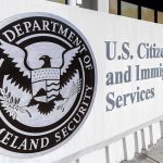 USCIS building exterior sign with DHS seal