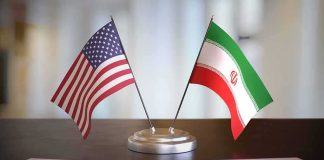 United States and Iran desk flags on a stand