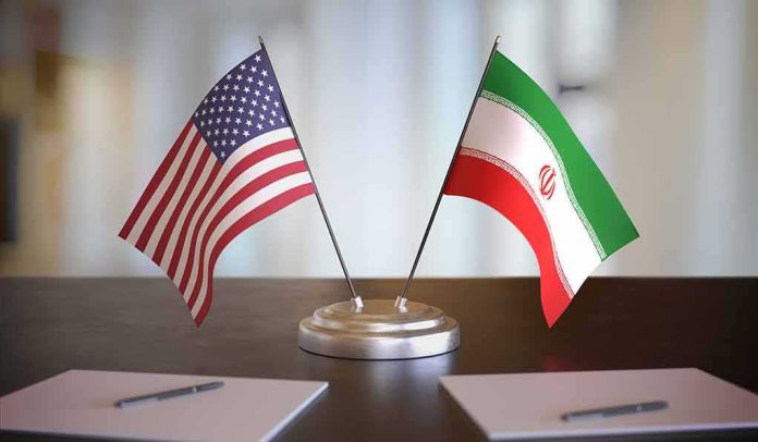 shutterstock_1609200817 United States and Iran desk flags on a stand