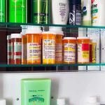 Universal Care’s Hidden Price: Time Medicine cabinet with prescription bottles and toiletries