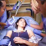Anchor’s Heart Scare Ignites Vaccine Firestorm Patient on hospital gurney surrounded by medical staff