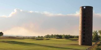 Armed Ex-Marine Halts Trump Golf Case Brick silo beside a golf course at sunset