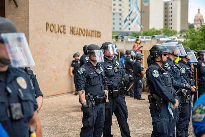 shutterstock_1747618742 Police officers in riot gear stand in formation outside a headquarters building