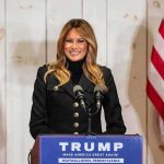 Putin Backchannel: Melania’s Quiet Win? woman speaking at podium with microphones and US flags