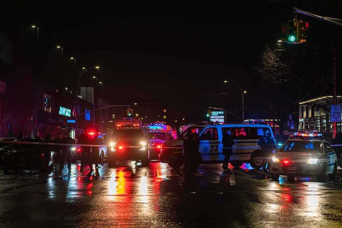 Nighttime police scene with flashing lights on a wet city street