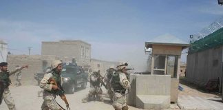 308 Hostages Out—Answers Still Vanish Soldiers in desert uniforms run past a checkpoint amid dust