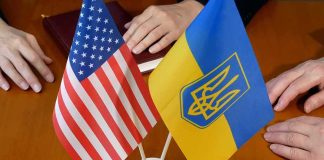 Ambassador Yanked Amid Corruption Whispers U.S. and Ukrainian flags on a table