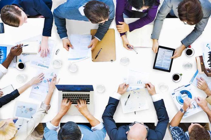 shutterstock_204774604 Group of professionals collaborating around a conference table