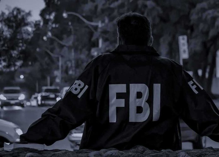 shutterstock_2150728473 FBI agent in jacket facing a city street at dusk