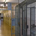 Prison corridor with barred doors