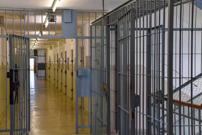 shutterstock_2284784009 Prison corridor with barred doors