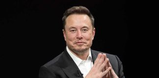 Nine-Figure Blitz: Musk Targets Midterms Man in a dark suit with hands clasped together