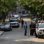 Arson Arrest Ignites Fury In Spokane Police officers secure a residential street with patrol cars and yellow tape