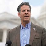 FBI Files Resurface — China Spy Fears Ignite man speaking at outdoor podium near government building