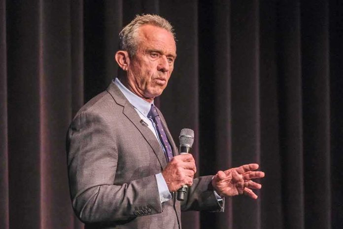 shutterstock_2341983447 man in a suit speaking into a microphone on stage