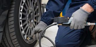 Tire Shock: Best-Sellers Vanish Mechanic inflating a car tire in a workshop