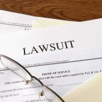 $32M Vanishes Inside Taylor Farms Legal documents labeled lawsuit on a desk