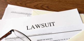 Legal documents labeled lawsuit on a desk