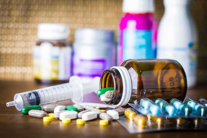 shutterstock_544348294 Medicine pills and syringe on table with brown bottle