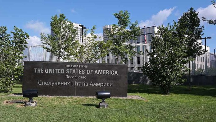 shutterstock_663456193 U.S. embassy sign in landscaped grounds