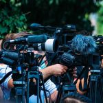 Evacuation Chaos: Toxic Tank Could Explode Anytime TV news cameras crowding together at an outdoor event